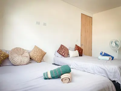 two beds with pillows on them in a room at Apt luxe laurles estadio 3alcobas in Medellín