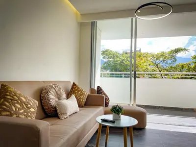 a living room with a couch and a table at Apt luxe laurles estadio 3alcobas in Medellín