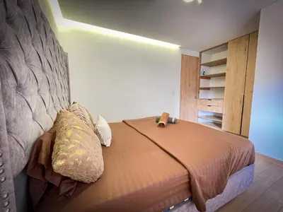 a bedroom with a bed with a headboard at Apt luxe laurles estadio 3alcobas in Medellín