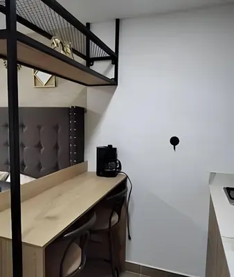 a room with a desk and a loft bed at Acogedor Loft en la floresta cerca al metro in Medellín