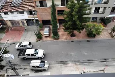 three cars parked in a parking lot in front of a building at Acogedor Loft en la floresta cerca al metro in Medellín