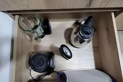 a wooden shelf with a bunch of electronics on it at Acogedor Loft en la floresta cerca al metro in Medellín