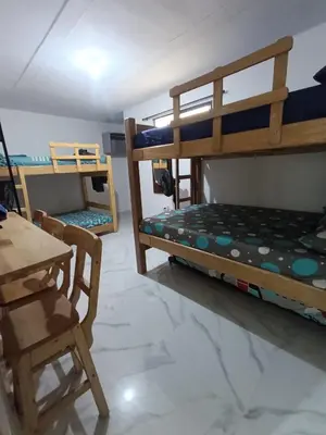 a room with two bunk beds and a table at E2P RENOVADO y BELLO APARTAMENTO EN LAURELES ESTADiO in Medellín