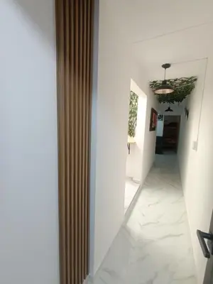 a hallway with white walls and a ceiling at E2P RENOVADO y BELLO APARTAMENTO EN LAURELES ESTADiO in Medellín