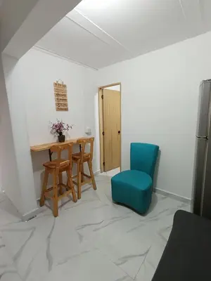 a dining room with a table and a blue chair at E2P RENOVADO y BELLO APARTAMENTO EN LAURELES ESTADiO in Medellín