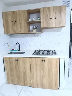 a kitchen with wooden cabinets and a sink at E2P RENOVADO y BELLO APARTAMENTO EN LAURELES ESTADiO in Medellín