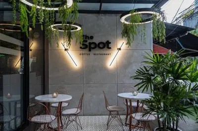 two tables and chairs in a restaurant with plants at The O by Seekers Medellín in Medellín
