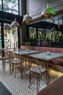 a group of tables and chairs in a restaurant at The O by Seekers Medellín in Medellín