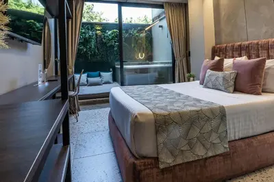 a bedroom with a bed and a large window at The O by Seekers Medellín in Medellín