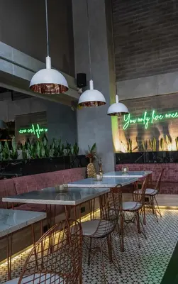 a group of tables and chairs in a restaurant at The O by Seekers Medellín in Medellín