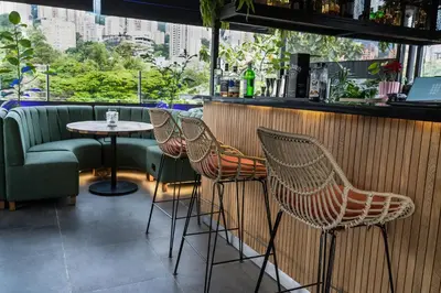 a row of chairs and a table in a bar at The O by Seekers Medellín in Medellín