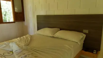 a bed with two pillows on it in a room at HOTEL CAMPESTRE LAS CAVERNAS in Mesa del Norte