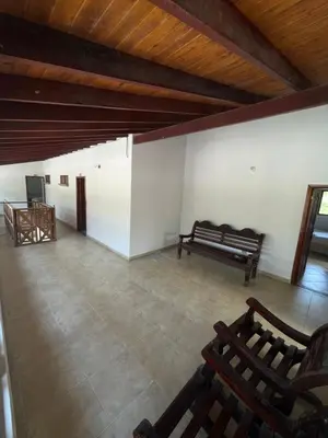 an empty room with benches and a wooden ceiling at HOTEL CAMPESTRE LAS CAVERNAS in Mesa del Norte