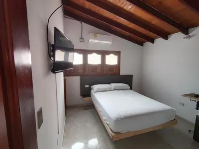 a bedroom with a bed and a tv in it at HOTEL CAMPESTRE LAS CAVERNAS in Mesa del Norte