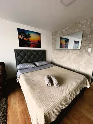 a bedroom with a large bed with two pillows on it at Aparta Estudio Confortable, Lujoso y Comodo en Milan in Manizales