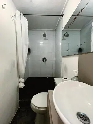 a bathroom with a white toilet and a sink at Aparta Estudio Confortable, Lujoso y Comodo en Milan in Manizales