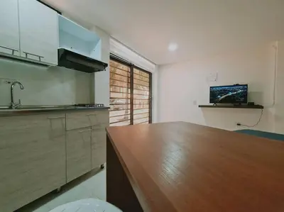 a kitchen with a wooden counter top in a room at Comfy loft in Laureles in Medellín