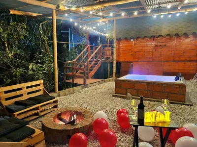 a room with a hot tub and a table with balloons at Cabaña en la Naturaleza con Jacuzzi - Santa Elena in Medellín
