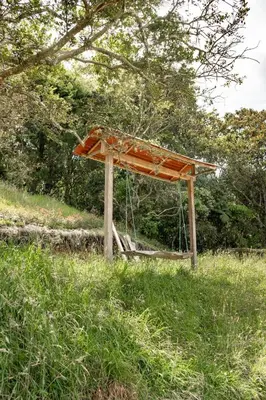 an orange shelter in a field of grass at Cabaña en la Naturaleza con Jacuzzi - Santa Elena in Medellín