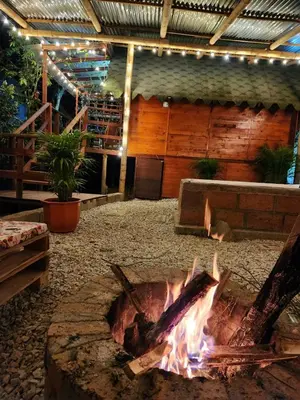 a fire pit in the middle of a building at Cabaña en la Naturaleza con Jacuzzi - Santa Elena in Medellín