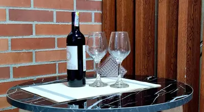 a bottle of wine sitting on a table with two wine glasses at 1BR Air Conditioned Studio Buenos Aires in Medellín