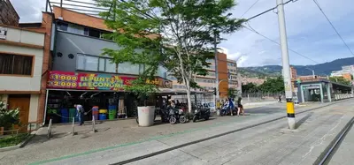 a street with motorcycles parked in front of a building at 1BR Air Conditioned Studio Buenos Aires in Medellín