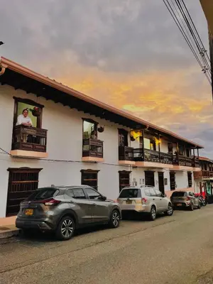 two cars parked in front of a building at Hotel Plenitud Jardín in Jardin