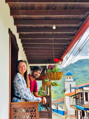 a man and a woman sitting on a balcony at Hotel Plenitud Jardín in Jardin