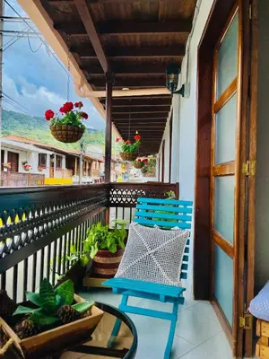 a blue chair on a balcony with a view at Hotel Plenitud Jardín in Jardin