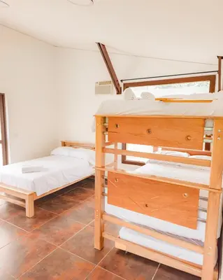 a bedroom with two bunk beds in a room at Hotel Villa Santa María in Santa Fe de Antioquia