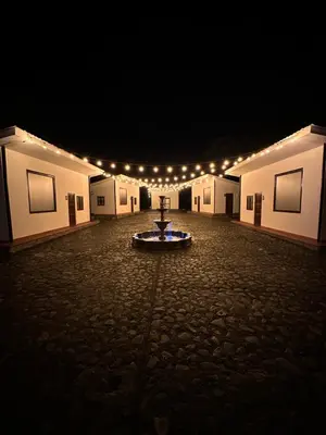 a large room with a table in the middle of it at night at Hotel Villa Santa María in Santa Fe de Antioquia