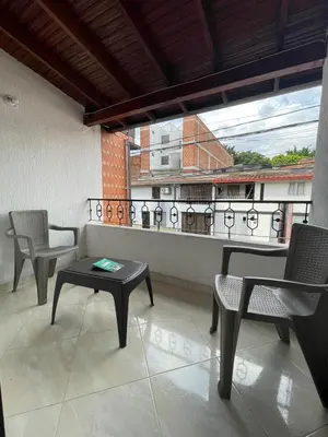 a room with chairs and a table and a balcony at Hotel San Pablo boutique H9 in Medellín