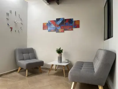 two chairs and a table in a room at Hermoso apartamento con estacionamiento in Medellín