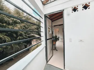 a glass door to a balcony with plants at Duplex apartment in Medellín