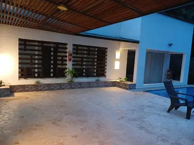 a patio with a chair and a house at Antokia in Santa Fe de Antioquia
