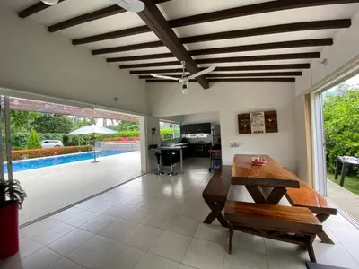 a living room with a table and a pool at Antokia in Santa Fe de Antioquia