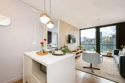 a kitchen and living room with a large window at Energy Living - Ultimate Condo in Medellin in Medellín