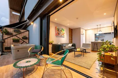 a living room with green chairs and a couch at Energy Living - Ultimate Condo in Medellin in Medellín