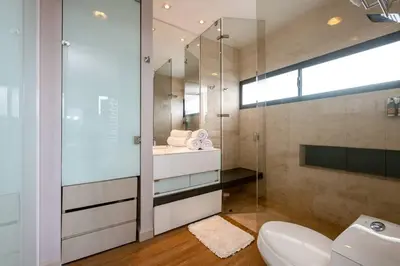 a bathroom with a glass shower and a toilet at Energy Living - Ultimate Condo in Medellin in Medellín