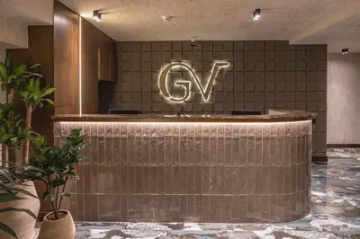 a lobby with a cyril sign on the wall at Golden Valley Hotel in Medellín