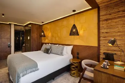 a hotel room with a bed and a desk and a desk at Golden Valley Hotel in Medellín