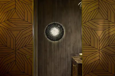 a hallway with a wooden door with a orb on it at Golden Valley Hotel in Medellín