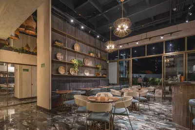 a restaurant with tables and chairs in a room at Golden Valley Hotel in Medellín