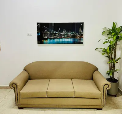 a couch in a living room with a picture on the wall at Apartamento en San Diego La Candelaria cerca al centro de Medellín in Medellín