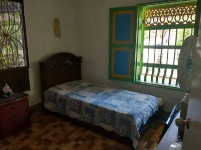 a bedroom with a bed and two windows at Cabaña 2 Montenegro La Pintada in La Pintada