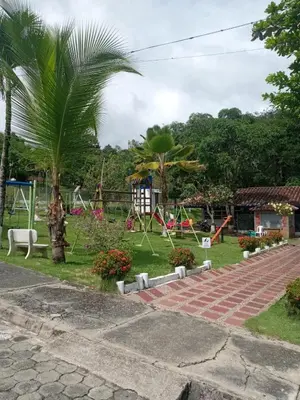 a park with a playground and palm trees at Cabaña 2 Montenegro La Pintada in La Pintada