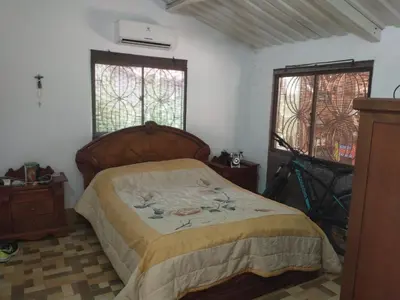 a bedroom with a bed and two windows at Cabaña 2 Montenegro La Pintada in La Pintada