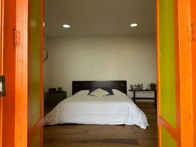a bedroom with a large bed in a room at Fabrica de Rios Glamping in Manizales