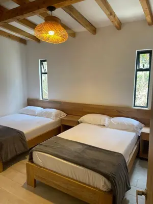 a bedroom with two beds and a chandelier at Serenity house Guatapé in Guatapé