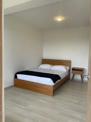 a bedroom with a bed with a wooden headboard at Serenity house Guatapé in Guatapé